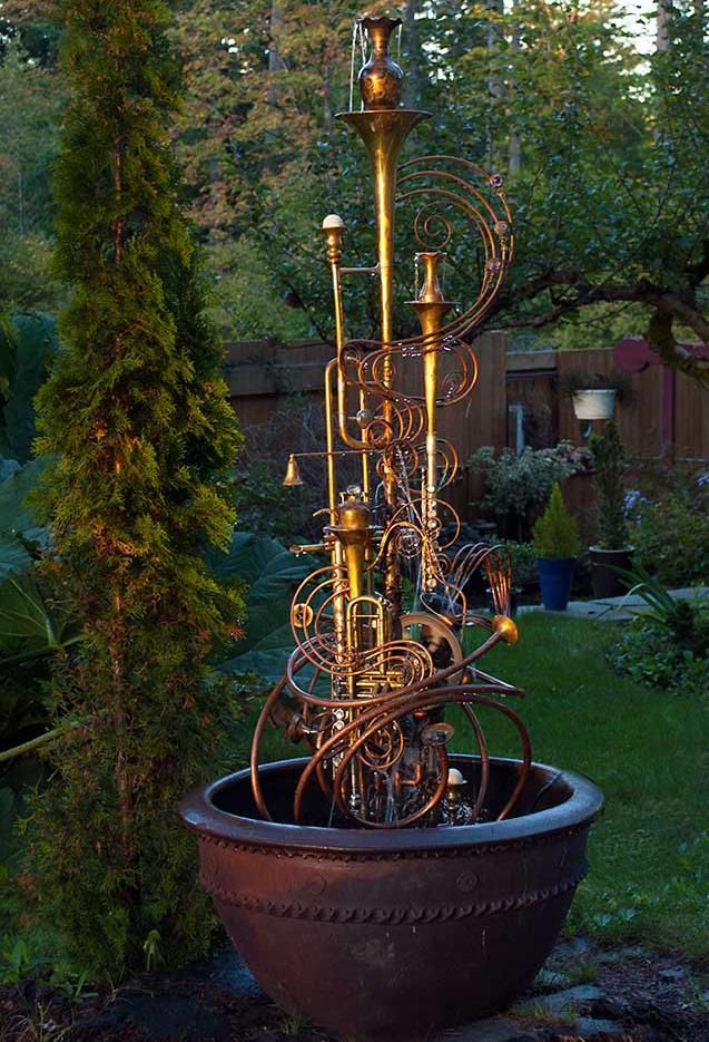 Silver Sax Fountain Musical Instrument fountain made from upcycled items including copper tube, a water wheel, a sax, a trumpet, a flute and an assortment of copper and brass collectable. It comes complete with pump. This fountain is currently available for purchase @ $ 2,400. Please call or email for further info and shipping details.